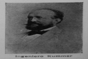 Ein Schwarz-Weiß-Foto eines bärtigen Mannes in einem Blazer und Brille, mit dem Text "Ingenlero Kummer, der Gründer der deutschen Revolution" unten.
