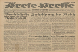 Schwarze und weiße Titelseite einer alten deutschen Zeitung mit einem ernst dreinblickenden Mann, der direkt in die Kamera schaut.