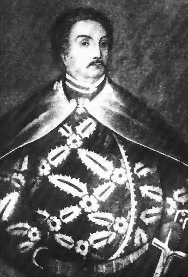 Schwarzes und weißes Foto von Papst Johannes Paul II. in Priestergewand, trägt eine schwarze Robe mit weißem Kragen und Manschetten, Hände gefaltet, strenger Gesichtsausdruck.