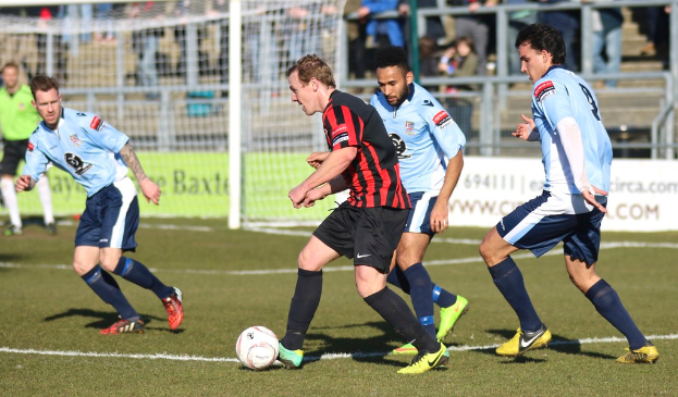 A group of people playing with a football.
