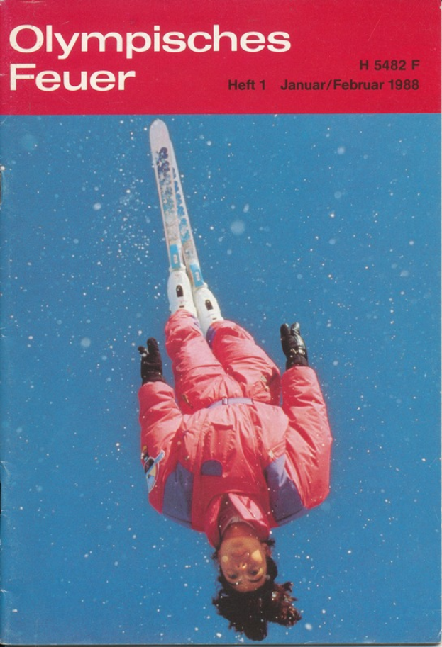 Ein Buchumschlag mit einem Skifahrer in der Luft, der eine Skiausrüstung trägt, und der Text "Olympische Spiele Feuer - Heft 1 - Januar/Februar 1988" deutlich zu sehen ist.