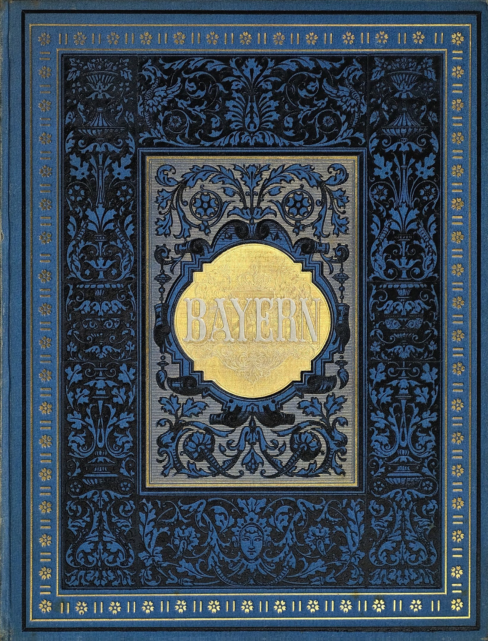 Ein blau-goldenes Buch mit dem Wort 'Bayern' auf dem Cover, verziert mit detaillierten Dekorationen.